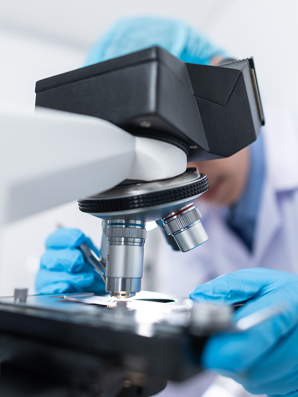 Photo of a lab technician analyzing a blood sample tied to the Masterjohn-Comprehensive test.